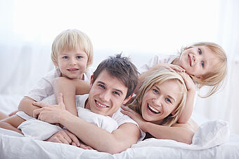 Happy family in bed